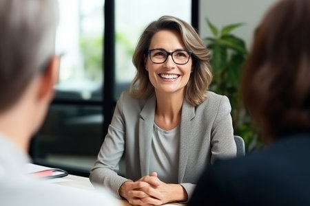 Smiling mature middle aged professional business woman banking loan managerの素材