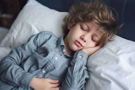 Sick child looking upset suffering from a stomach acheの素材