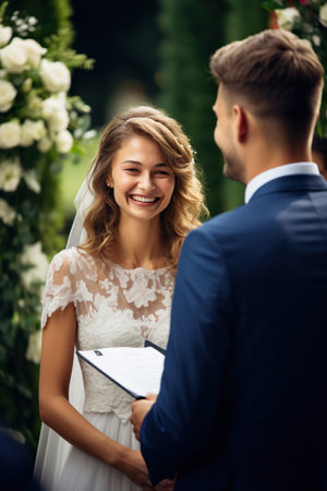 A young and beautiful couple getting married, exchanging vows with a partner.の素材
