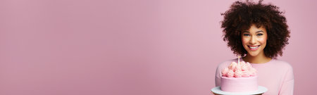 Happy African American woman with birthday cake on pink backgroundの素材
