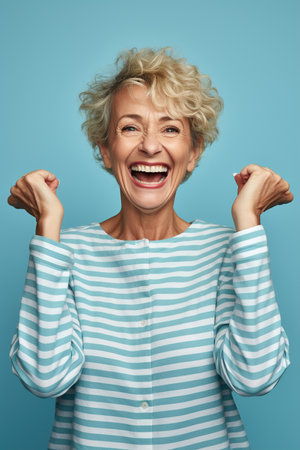 Elderly exultant overjoyed jubilant woman 50s years old wear light striped shirt look camera spread hands say wow isolated on plain pastel blue cyan color background studio portrait Lifestyle conceptの素材