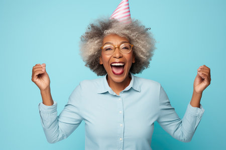 Elderly exultant overjoyed jubilant African American woman 50s years old wear light striped shirt look camera spread hands say wow isolated on plain pastel blue cyan color background studio portrait Lifestyle conceptの素材