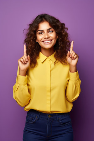 Photo of thoughtful dreamy woman dressed yellow shirt looking pointing two thumbs empty space isolated purple color backgroundの素材