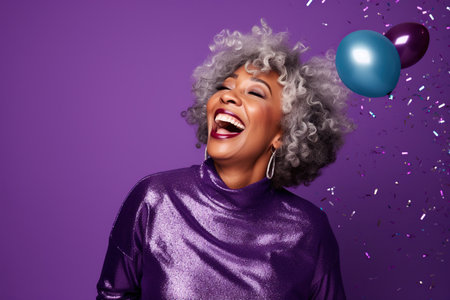Happy Mature African American woman with Gray Hair Celebrating New Years Party on a pink Background with Copy Spaceの素材