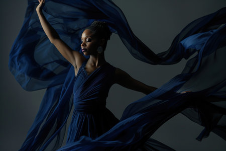 African American Woman in Navy waving dress with flying fabric.の素材