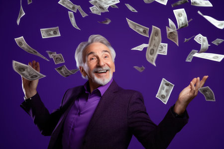 senior man and flying money on studio purple backgroundの素材
