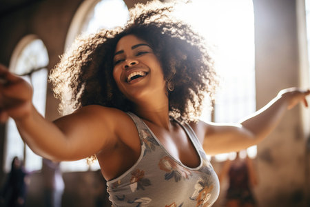 Confident body moves: Plus size woman having fun with her body in a dance studioの素材