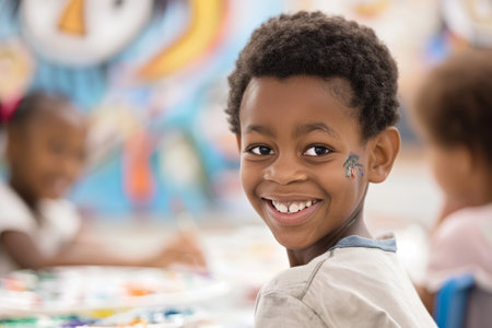 A young Afro-American boy exudes happiness as he engages in an art and creativity class, his smile reflecting the pleasure of creating something new.の素材