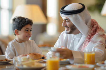 A dedicated Arab father and son share a joyful breakfast in the hotel, cherishing their time together and creating lasting memories against a backdrop of hospitality and comfort.の素材