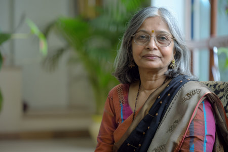 A welcoming Indian businesswoman holds a conversation with a job candidate during an office interview, demonstrating her amiable nature and adeptness in assessing candidates.の素材