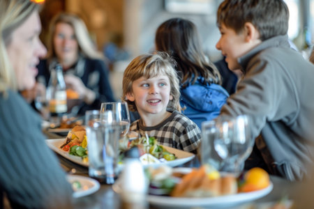 A special Parents Day brunch at a local restaurant, families gathered around the table, enjoying delicious food and engaging in meaningful conversations, celebrating the bond between parents and children.の素材