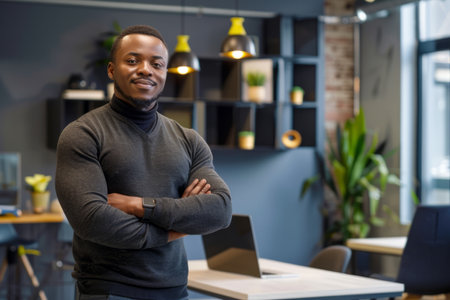 an African American entrepreneur displaying confidence and professionalism in a modern startup office.の素材