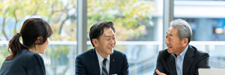 a Japanese business consultant advising clients in a bright, modern officeの素材