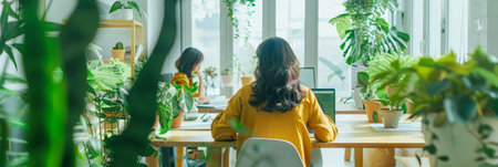 a Southeast Asian startup team designing eco-friendly packaging in a bright, creative officeの素材