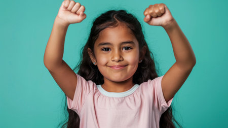 a Hispanic girl showing determination on a studio backgroundの素材