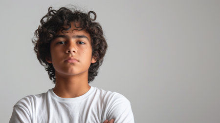 a Hispanic teenager looking determined on a studio backgroundの素材