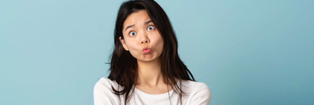 a Japanese woman looking puzzled on a studio backgroundの素材