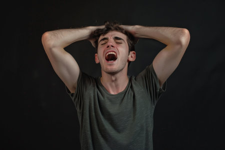 a Caucasian man expressing anxiety on a studio backgroundの素材