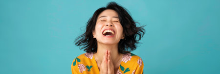 a Japanese woman showing joy on a studio backgroundの素材