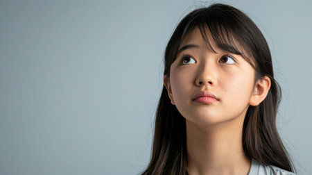 a Japanese teenager looking determined on a studio backgroundの素材