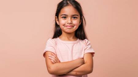 a Hispanic girl showing determination on a beige studio backgroundの素材