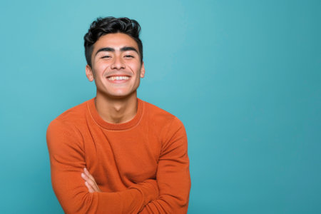 a Hispanic man expressing contentment on a blue studio backgroundの素材