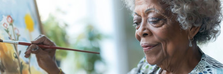 an African American retired woman practicing watercolor paintingの素材