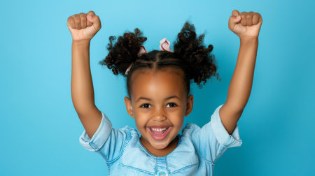 an African American girl showing excitement on a studio backgroundの素材