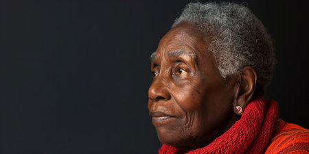 an African American elderly person with a serene expression on a studio backgroundの素材