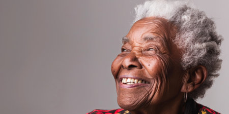 an African American elderly person with a cheerful expression on a studio backgroundの素材