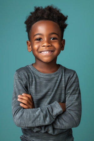 an African American child feeling proud on a studio backgroundの素材