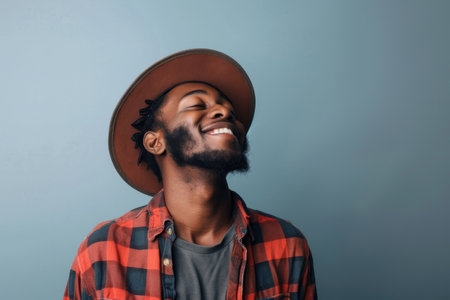 an African American man expressing contentment on a studio backgroundの素材