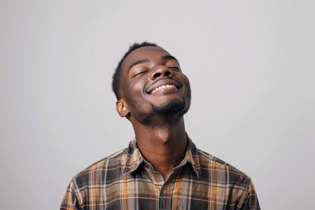 an African American man expressing contentment on a studio backgroundの素材