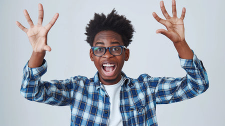 an African American teenager showing excitement on a studio backgroundの素材