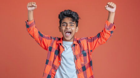 an Indian teenager showing excitement on a studio backgroundの素材