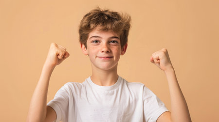 a Caucasian teenager showing determination on a beige studio backgroundの素材