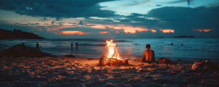 Beach background with a bonfire at night and people sitting around it.の素材