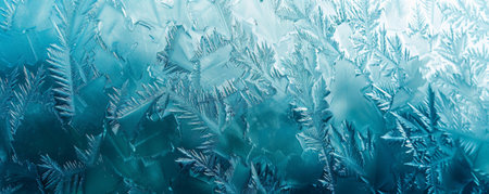 Ice background with a frosted window effect, where the glass is covered in a layer of ice and frost. The intricate frost patterns are highlighted against a backdrop of cool blue tones.の素材