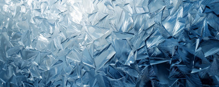 Ice background with a shimmering, icy surface, resembling a frozen mirror. The light reflections create a dazzling effect, with shades of blue and white enhancing the cold, pristine appearance.の素材