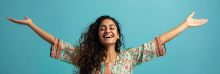 an Indian woman showing joy on a studio backgroundの素材