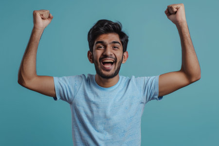 an Indian man expressing happiness on a studio backgroundの素材