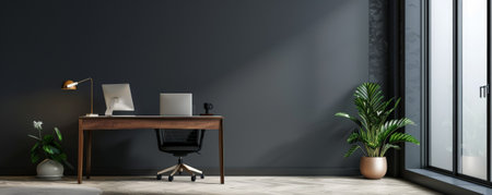 A modern home office with a stylish desk and ergonomic chair, positioned against a charcoal gray wall. The dark wall provides a dramatic backdrop, emphasizing the room's clean and functional design.の素材
