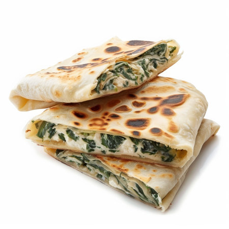 A traditional Turkish gÃÂ¶zleme, savory flatbread stuffed with spinach and feta cheese, folded and served hot, isolated on white background.の素材