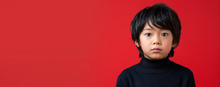 Unhappy school-age Japanese boy against a red background banner with copy space.ai generatedの素材