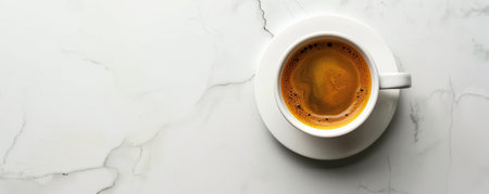 Top view of a hot coffee cup with a smooth espresso, placed on a minimalist white table. The simplicity of the scene draws attention to the deep, rich color of the coffee.の素材
