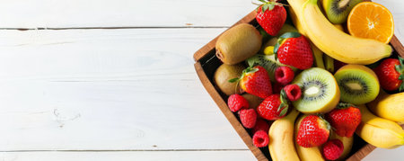 A wooden basket overflowing with nutritious fruits like kiwis, strawberries, and bananas, top view, with a white background and space for text.の素材