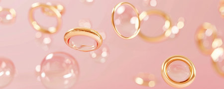 Gold rings floating in front of a soft pink background, creating a luxurious and delicate feel.の素材