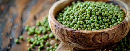 Close-up of a rustic wooden bowl filled with pea groats, showing their texture and natural color on a wooden table.の素材