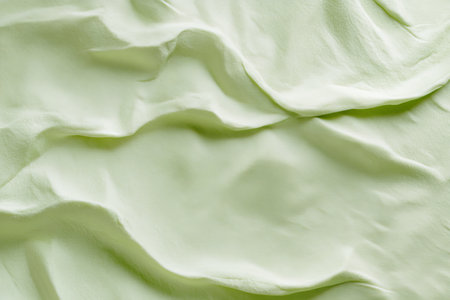 A light honeydew-green surface with a soft, velvety texture. The fresh, pastel tone and luxurious texture create a refreshing and refined backdrop.の素材