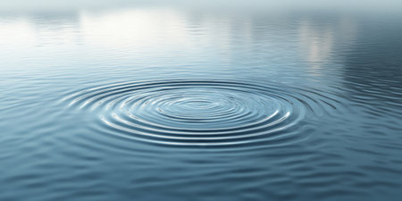 Clear, undisturbed water with subtle, circular ripples spreading from a central point. The water's surface is pristine, reflecting the sky and creating a harmonious, zen-like atmosphere. Perfect for serene, natural backgrounds.の素材
